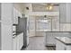 Open kitchen with stainless steel appliances, white cabinets, and wood-look flooring at 2247 W Highland St, Chandler, AZ 85224
