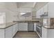 Bright kitchen with stainless steel appliances, granite countertops, and white cabinets at 2247 W Highland St, Chandler, AZ 85224