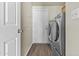 A modern laundry room with wood-look floors and modern appliances at 2247 W Highland St, Chandler, AZ 85224