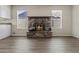 Cozy living room featuring a stone fireplace and wood-look floors at 2247 W Highland St, Chandler, AZ 85224