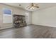 Living room features a stone fireplace, wood-look flooring, neutral walls, and abundant natural light at 2247 W Highland St, Chandler, AZ 85224