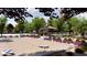 Community recreation area with cornhole, playground, picnic tables, and lush landscaping at 23356 W Atlanta Ave, Buckeye, AZ 85326