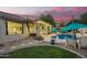 Lush backyard with a pool, covered patio, and meticulous landscaping perfect for entertaining at 2406 E Oakland St, Chandler, AZ 85225