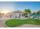 Backyard featuring a pool, covered patio, and ample green space, perfect for relaxation and entertainment at 2406 E Oakland St, Chandler, AZ 85225