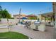 Backyard has pool, seating, BBQ, firepit, landscaped yard, and covered patio perfect for outdoor entertaining and relaxing at 2406 E Oakland St, Chandler, AZ 85225