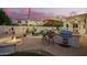 Beautiful backyard with a built-in grill, outdoor seating, and a cozy fire pit, perfect for entertaining at 2406 E Oakland St, Chandler, AZ 85225