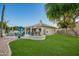 Backyard has pool, seating, BBQ, firepit, and landscaped yard perfect for outdoor entertaining and relaxing at 2406 E Oakland St, Chandler, AZ 85225