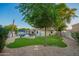 Backyard has pool, seating, BBQ, firepit, landscaped yard, and mature trees perfect for outdoor entertaining and relaxing at 2406 E Oakland St, Chandler, AZ 85225
