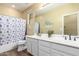 Bathroom featuring a shower/tub combo, double sinks, and stylish nautical decor at 2406 E Oakland St, Chandler, AZ 85225