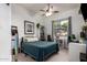 Bright bedroom with a ceiling fan, large window overlooking the backyard, and decorated with modern-style artwork and furniture at 2406 E Oakland St, Chandler, AZ 85225