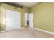 Bright bedroom showcasing the closet space, with a view into another room at 2406 E Oakland St, Chandler, AZ 85225