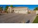 Lovely home featuring a three-car garage, desert landscaping, and a gated courtyard on a large concrete driveway at 2406 E Oakland St, Chandler, AZ 85225