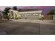 A well-lit, single story home with a three car garage, desert landscaping, and a extra wide driveway at 2406 E Oakland St, Chandler, AZ 85225
