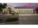 A well-lit, single story home with a three car garage, desert landscaping, and a circular driveway at 2406 E Oakland St, Chandler, AZ 85225