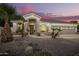 Charming home featuring a rock garden, well-maintained landscaping, and warm lighting at 2406 E Oakland St, Chandler, AZ 85225