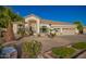 Single-story home with a three-car garage, desert landscaping and neutral color scheme under a clear blue sky at 2406 E Oakland St, Chandler, AZ 85225