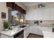 Bright kitchen with granite countertops, white cabinets, and a large window overlooking the backyard at 2406 E Oakland St, Chandler, AZ 85225