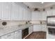 Kitchen featuring white cabinets, granite countertops, stainless steel appliances, and wood-look flooring at 2406 E Oakland St, Chandler, AZ 85225