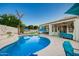 A backyard featuring a pristine pool, covered patio, and lounge area perfect for outdoor relaxation at 2406 E Oakland St, Chandler, AZ 85225