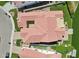 Aerial view showing the home's red-tiled roof, central courtyard, and proximity to a beautiful lake at 2454 W Hope Cir, Chandler, AZ 85248