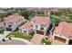 An aerial view of a two-story home showing a red tile roof near a scenic lake with a lush green landscape at 2454 W Hope Cir, Chandler, AZ 85248