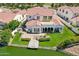 An aerial view of a two-story home featuring a backyard with a dock, covered patio, and lake access at 2454 W Hope Cir, Chandler, AZ 85248