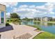 A backyard patio leading to a tranquil pond surrounded by well-maintained landscaping at 2454 W Hope Cir, Chandler, AZ 85248