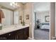 Bathroom featuring a light countertop vanity with dark wood cabinets with a view into the bedroom at 2454 W Hope Cir, Chandler, AZ 85248