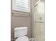 Bathroom showcasing a toilet, clear glass shower, and a window with shutters at 2454 W Hope Cir, Chandler, AZ 85248