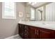 Bathroom featuring dark wood cabinets, white countertops, and a large mirror over the vanity at 2454 W Hope Cir, Chandler, AZ 85248