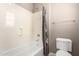 Bathroom featuring a shower-tub combo with white fixtures, complemented by neutral walls, offering a clean and functional space at 2454 W Hope Cir, Chandler, AZ 85248