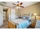 Comfortable bedroom features a stylish bed frame, soft lighting, and access to an en-suite bathroom at 2454 W Hope Cir, Chandler, AZ 85248