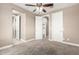 Bedroom with neutral walls, carpet flooring, and multiple doors to adjoining rooms at 2454 W Hope Cir, Chandler, AZ 85248