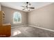 Bedroom boasting a large window with shutters, complemented by neutral walls and carpeted floors for a serene ambiance at 2454 W Hope Cir, Chandler, AZ 85248