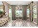Elegant dining room with chandelier, large windows, and custom window treatments at 2454 W Hope Cir, Chandler, AZ 85248