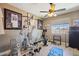Well-equipped home gym with various exercise machines, weights, and sports memorabilia displayed on the walls at 2454 W Hope Cir, Chandler, AZ 85248