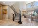 Grand foyer showcasing a curved staircase, high ceilings, and an open view into the living and dining areas at 2454 W Hope Cir, Chandler, AZ 85248