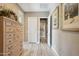 Hallway with wood-look tile floors and a wooden dresser with decorative hardware at 2454 W Hope Cir, Chandler, AZ 85248