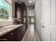 Hallway featuring dark wood cabinetry and granite countertops, leading to other rooms at 2454 W Hope Cir, Chandler, AZ 85248
