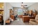 Spacious home office featuring multiple desks, built-in shelving, and a cozy seating area at 2454 W Hope Cir, Chandler, AZ 85248