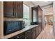 Well-appointed kitchen with dark wood cabinets, granite countertops, and stainless steel appliances at 2454 W Hope Cir, Chandler, AZ 85248