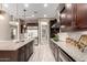 Spacious kitchen with granite countertops, stainless steel appliances, and wood-look tile flooring at 2454 W Hope Cir, Chandler, AZ 85248