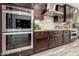 Modern kitchen featuring stainless steel appliances, dark wood cabinetry and stylish tile backsplash at 2454 W Hope Cir, Chandler, AZ 85248