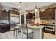 Stylish kitchen with a large island, granite countertops, and stainless steel appliances, perfect for modern living at 2454 W Hope Cir, Chandler, AZ 85248