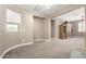 Open-concept living room with neutral walls, light carpet, and views into additional flexible living space at 2454 W Hope Cir, Chandler, AZ 85248
