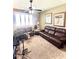 Inviting living room features a comfortable brown leather sofa and large windows providing natural light at 2454 W Hope Cir, Chandler, AZ 85248