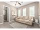 Cozy living room featuring a sofa, ceiling fan and shuttered windows, offering a welcoming atmosphere at 2454 W Hope Cir, Chandler, AZ 85248