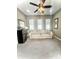 Cozy living room with a comfortable sofa, mini fridge, and large windows providing lots of natural light at 2454 W Hope Cir, Chandler, AZ 85248