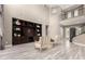 Living room featuring a dark wood built-in cabinet, tile floors, and comfortable seating at 2454 W Hope Cir, Chandler, AZ 85248