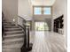 Bright living room with chandelier, staircase, tile floors, and sliding glass doors to backyard at 2454 W Hope Cir, Chandler, AZ 85248